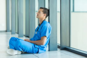 tired doctor sitting on the floor